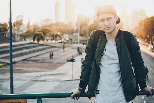 person man sitting on railings people