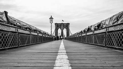 person people walking on bridge black-and-white
