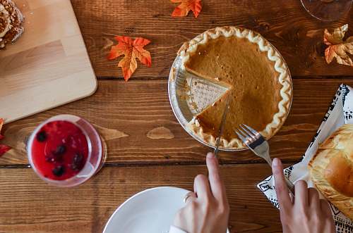 person person holding table knife about to slice pancake leaf