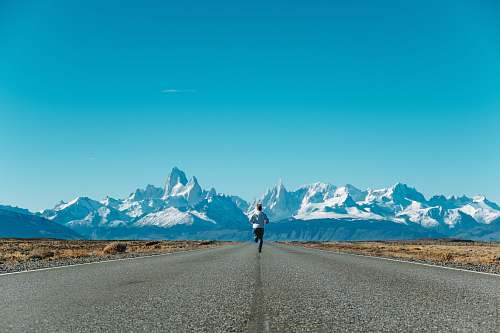 person person running on road at daytime road