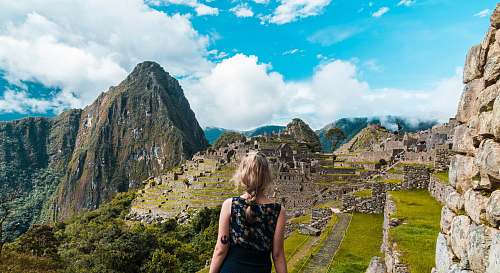 person woman facing Machu Picchu people