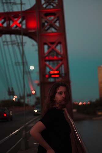 person woman standing near red bridge arch argentina