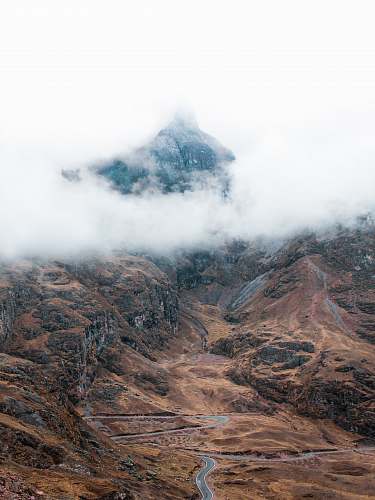 peru aerial photo of gray road near mountain under white clouds during daytime cusco