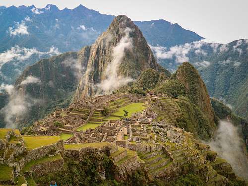 nature green and brown mountain under white clouds at daytime mountain range