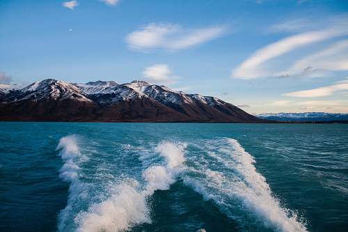 glacier mountain surrounded by body of water ice