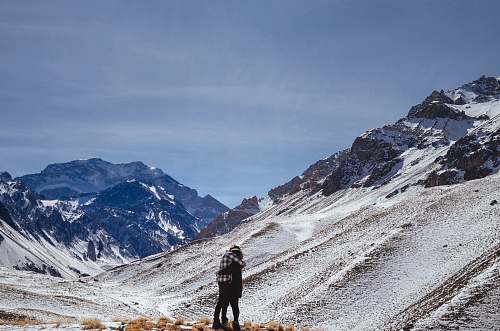 ice two people hugging on foot of snowy mountain snow