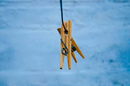 clothesline brown wooden clothes pin on gray metal hook clothespin