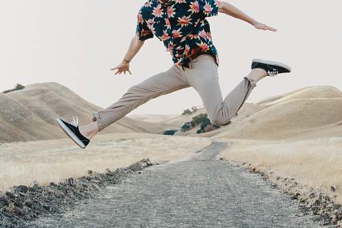 person man in black shirt and gray pants jumping human