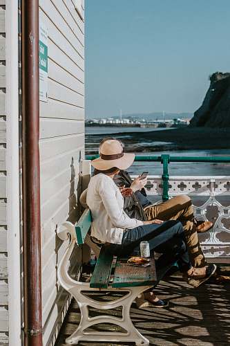 people man and woman sitting on bench human