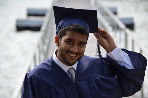 people man holding his graduation cap graduation