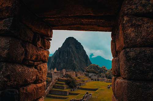 cusco green mountain under cloudy sky rock