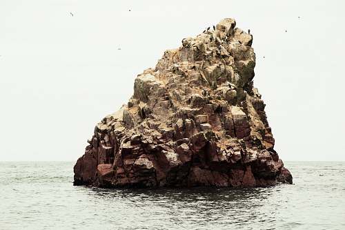 ocean rocky formation near the body of water rock