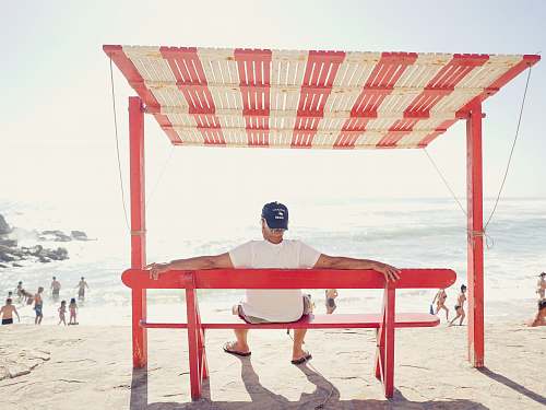 people man sitting on bench near beach silveira