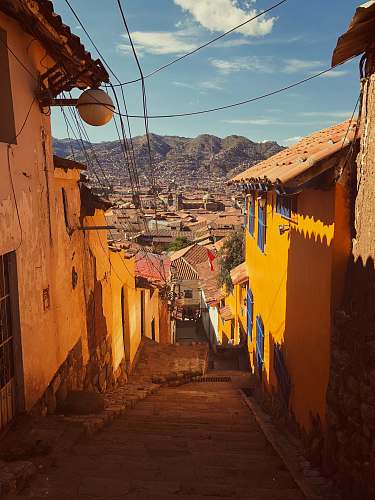 building orange houses near green mountain town