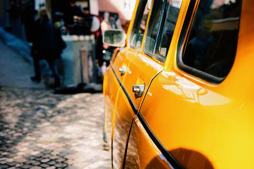 cab yellow car beside street car