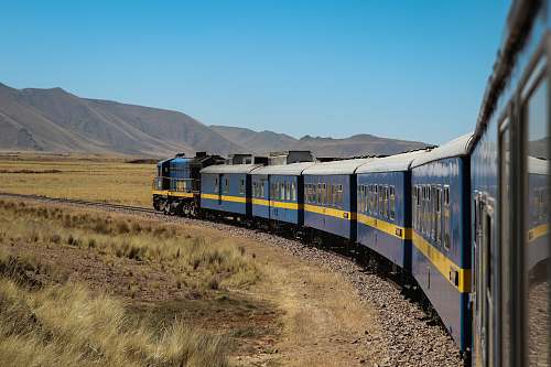 transportation blue train during daytime train track