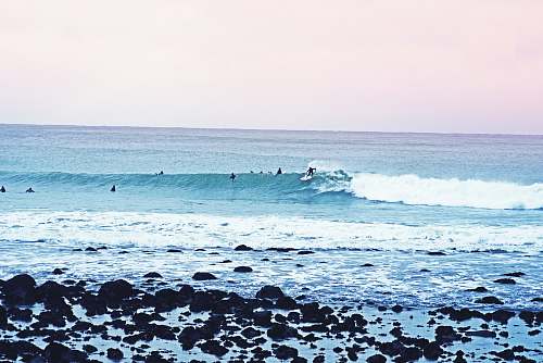ocean people surfboarding during daytime new zealand