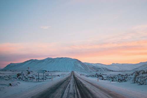 snow landscape photography of snow covered road and mountain iceland