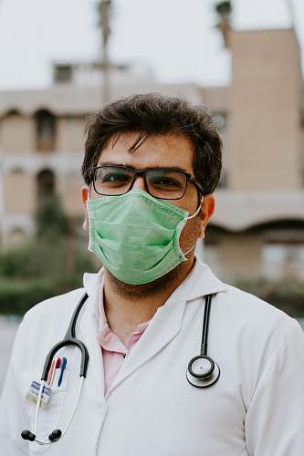 clothing man in white scrub suit wearing green mask lab coat