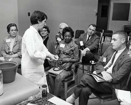 person grayscale photo of people inside room black-and-white