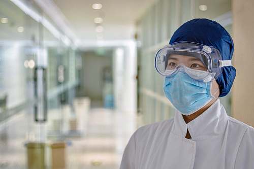 person man in white dress shirt wearing blue face mask apparel
