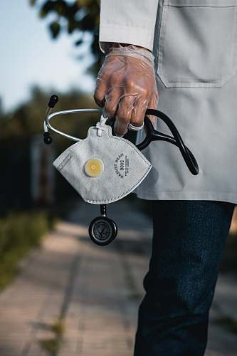 person person in blue denim jeans with gray and black metal padlock stethoscope