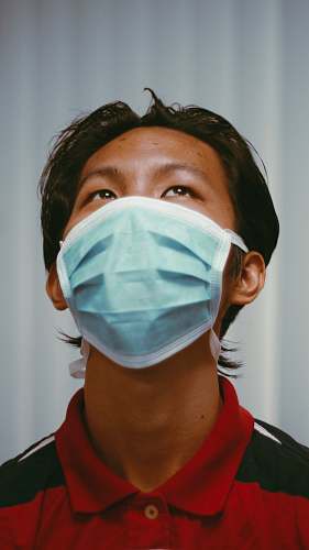 doctor woman in red shirt wearing white face mask person
