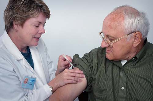 person woman injecting syringe on mans arm accessory