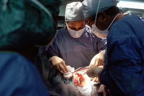 human doctor and nurse during operation surgery