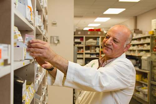 human man in white dress shirt holding white paper shelf