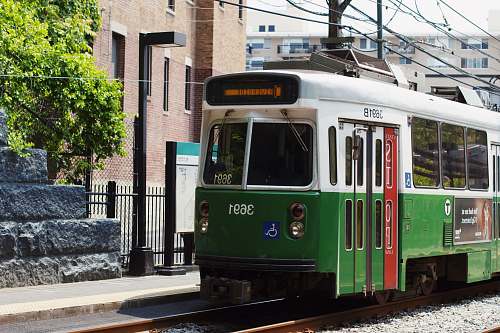  green and white tram on road during daytime 