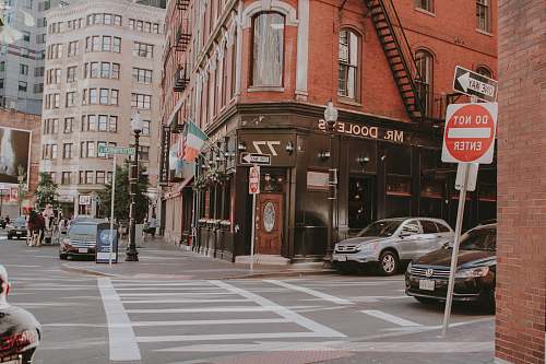 automobile person standing near pedestrian lane during daytime car