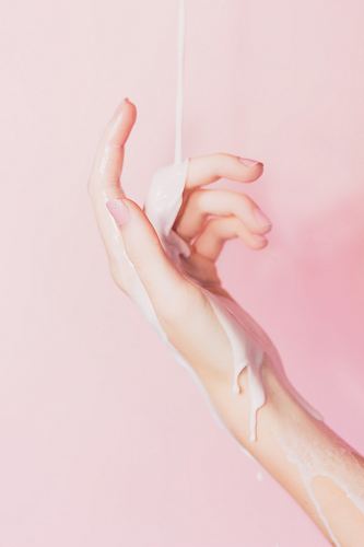 cream sliding on woman hand