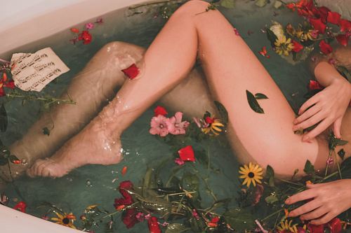 bathtub with water and flowers