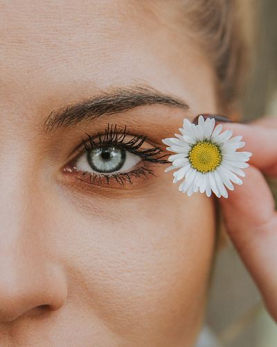 white petaled flower near woman eye