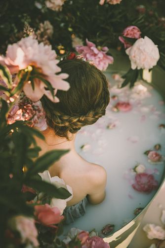 woman beside pink and purple flowers