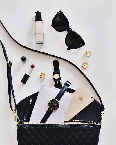 women's sunglasses and black bag with watch and iPhone 6