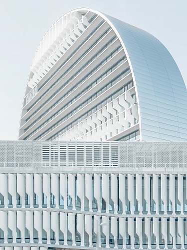 white mirrored building under blue sky arch