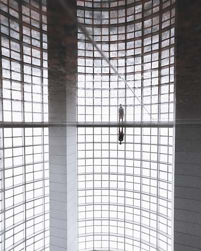 singapore person standing inside concrete building reflection