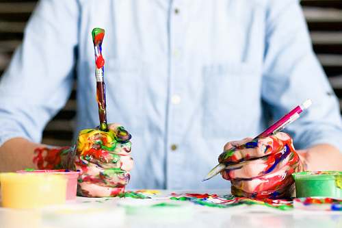 design person holding click pen painting