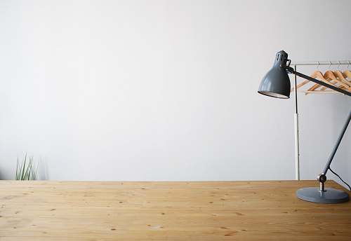 desk gray balanced-arm lamp on brown wooden table wood