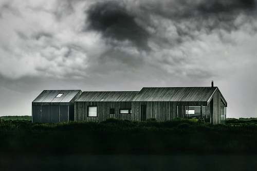 rural grayscale photo of wooden barn outdoors