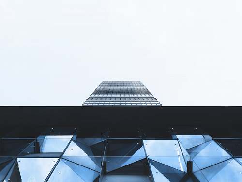 city high-rise building under white sky skyscraper