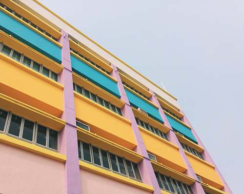 housing low angle photography of colorful building sky