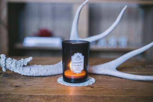 antler scented candle near deer horn rustic