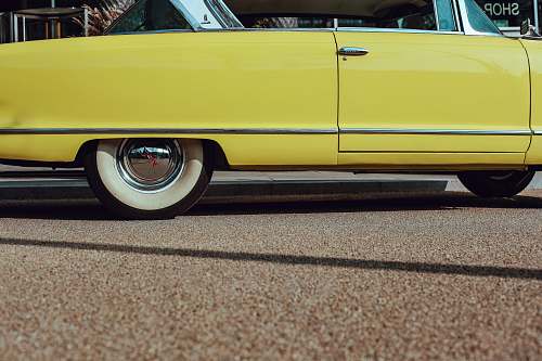automobile photo of yellow coupe on road transportation
