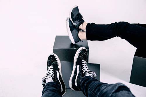 trainers pair of white-and-black Vans high-top sneakers black