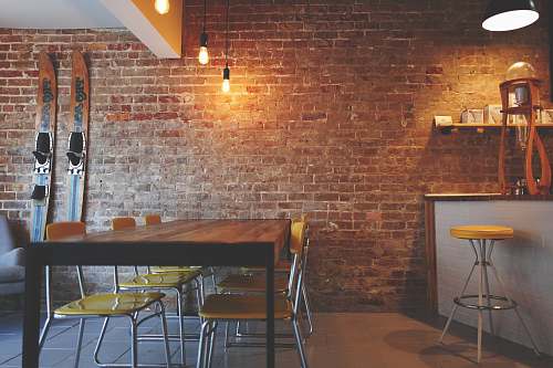 brick brown wooden dining table near white and brown mini bar chair
