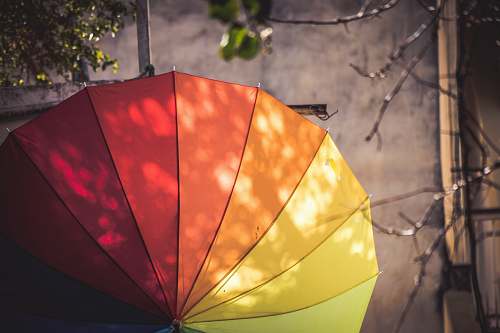 pottery multi-colored umbrella hanged on pole potted plant