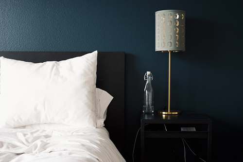 lamp gray table lamp beside white bed pillow bedroom